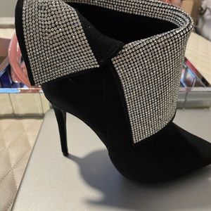 Suede pointy toe ankle booties with rhinestone details.